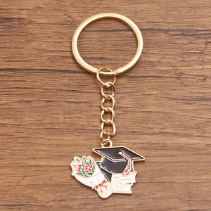 Graduation keychain featuring mortarboard, diploma, and floral charms in gold finish