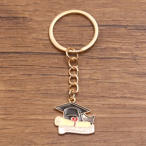 Detailed view of graduation keychain with black mortarboard and Graduate scroll pendant