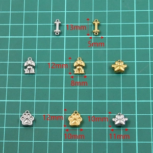 Stainless steel animal charms set including gold and silver dog, bone, and paw pendants