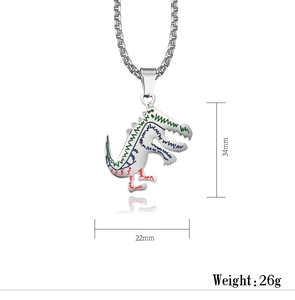 Close-up of silver dinosaur pendant with green blue red stripes and box chain