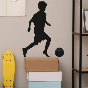 Minimalist black PVC silhouette wall sticker of a young boy playing football for bedroom decor