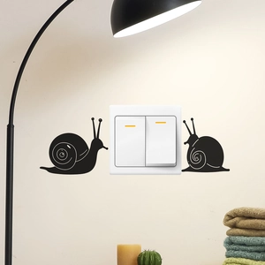 Minimalist black snail silhouette wall stickers around light switch for home decor
