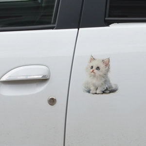 Cute white fluffy kitten car sticker with blue eyes on a white vehicle door