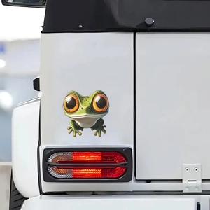 Cartoon big eye frog car sticker in green and orange on white vehicle body surface