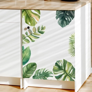 Tropical monstera leaf wall decals on white cabinet with natural sunlight shadows