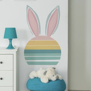 Minimalist rabbit wall sticker with colorful stripes in a cozy kids room setting