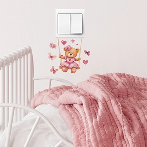Cartoon brown bear on a swing wall sticker for light switches in a pink nursery room