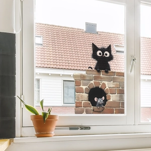Cartoon black cat and mouse wall sticker on a red brick wall for home glass decoration