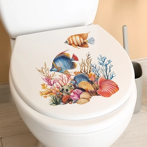 Detailed watercolor coral and tropical fish decals applied to a white bathroom toilet lid