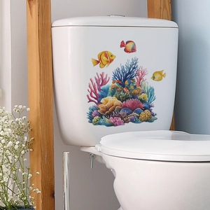 Detailed view of colorful coral and tropical fish decals on a white toilet tank