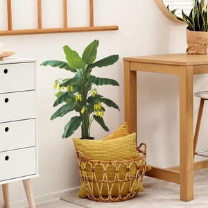 Artificial banana leaf potted plant with yellow flowers in a black planter for home decor