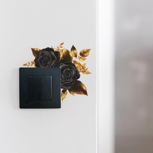 Elegant black and gold rose flower wall decal sticker surrounding a modern light switch