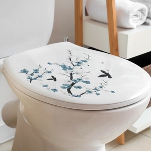 Chinese style floral bird wall sticker on a white toilet lid in a clean bathroom scene