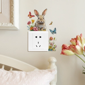 Charming rabbit and butterfly wall sticker decorating a power outlet in a cozy bedroom
