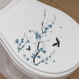 Detail view of ink-style floral and bird stickers applied to a white toilet lid cover