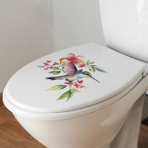 Self-adhesive toilet lid decal featuring colorful hummingbird and pink hibiscus flowers