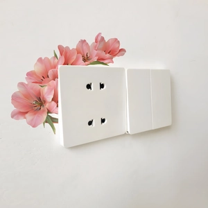 Nahaufnahme von minimalistischem weißem ultradünnem Doppelsteckdosen-Schalter-Set