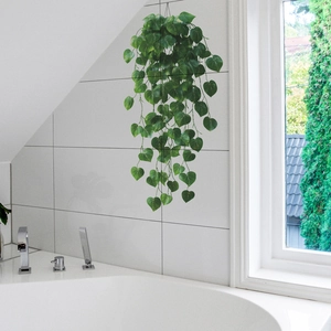 Hanging artificial pothos plant with green heart leaves for home wall decoration