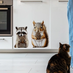Cute squirrel and raccoon wall stickers with a real cat in a modern white kitchen scene