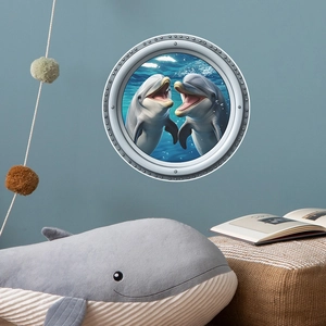 3D porthole wall decal featuring two dolphins swimming in a vibrant blue ocean world