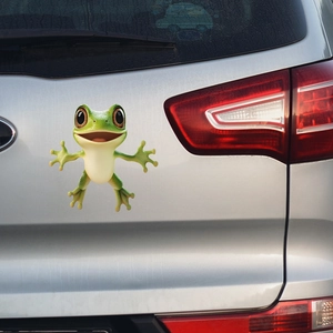 Close-up of 3D green cartoon frog waterproof vinyl car sticker on silver trunk surface