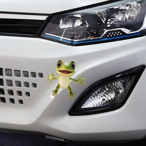 3D cartoon green frog car sticker on a white bumper showing realistic waterproof PVC texture