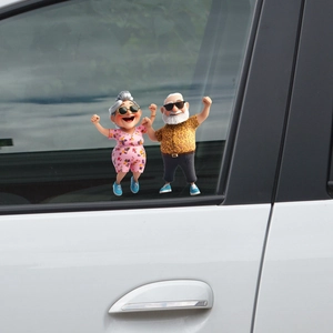 Cheerful dancing senior couple 3D cartoon car decal applied on a white vehicle window