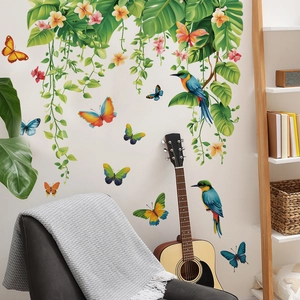 Tropical wall decals featuring green monstera leaves birds and flowers for home decor