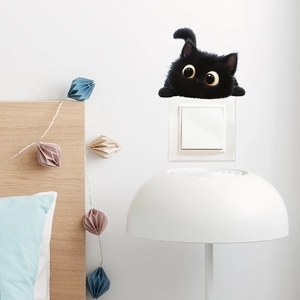Detail showing cartoon peeking black cat wall sticker applied near a light switch
