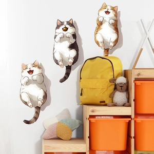 Set of three cute cartoon cats wall stickers in a bright nursery with colorful decor