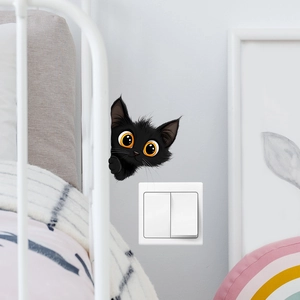 Cute black cat wall sticker peeking from behind a bed frame in a modern bedroom