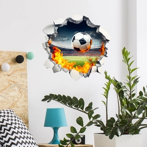 3D wall sticker featuring a soccer ball breaking through wall with flames for bedroom decor
