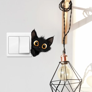 Cartoon black cat wall sticker peeking over a white light switch in a cozy home setting