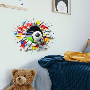 3D football wall sticker with colorful paint splashes breaking through a white brick wall