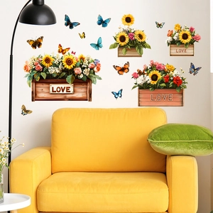 Floral wall decals with sunflowers and butterflies in baskets over yellow sofa