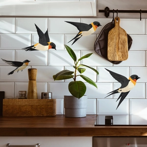 Realistic swallow wall decals flying over a modern white tiled kitchen background