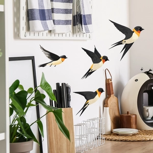 Detailed view of four realistic swallow wall stickers in flight on a white living room wall