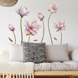 Detail of pink magnolia wall stickers featuring large floral blossoms on a bedroom wall