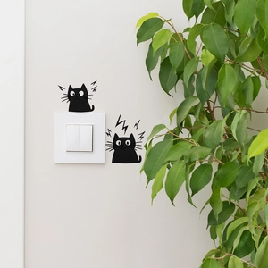 Detail view of black cartoon cat PVC wall stickers applied around a light switch