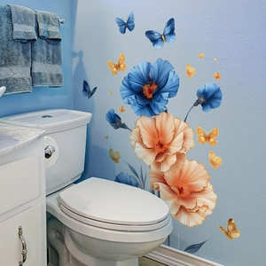Self-adhesive floral wall stickers with blue flowers and golden butterflies on a blue wall
