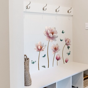 Detail of pink magnolia wall stickers and blue butterflies on a white paneled wall