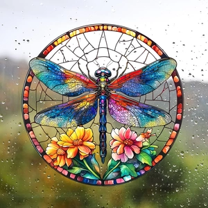 Close-up of colorful stained glass dragonfly window sticker with raindrops on glass surface