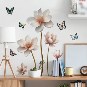 Detail of 3D magnolia flower wall stickers and colorful butterflies on a white living room wall