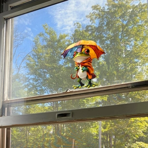 Static UV window cling featuring a colorful cartoon frog with orange cape and rainbow umbrella