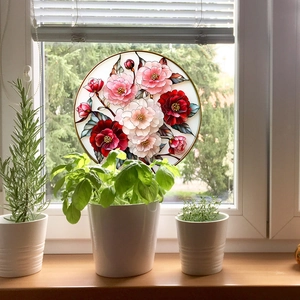 Floral stained glass suncatcher with pink roses and green leaves on window