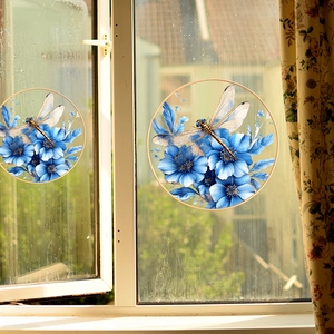 Detail of round static cling window film with blue floral and dragonfly art design