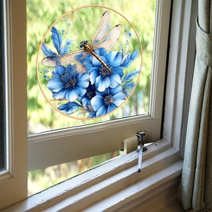 Close-up of circular glass window film with golden dragonfly and blue floral patterns
