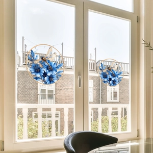 Floral window decal featuring blue flowers and golden dragonflies on a glass surface