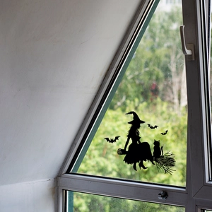 Halloween window cling featuring a black witch on a broom with bat silhouettes on glass