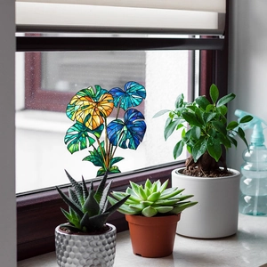 Stained glass monstera leaf window decal with vibrant green and amber gradients